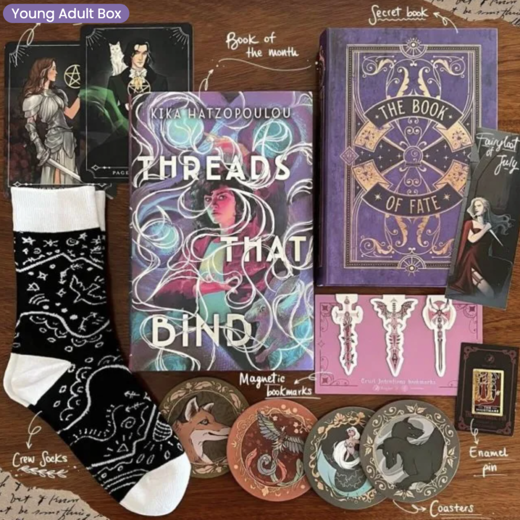 July 2023 YA FairyLoot box showing all the extra items such as stickers, socks, andbookmarks,along with the “Book of the month”
