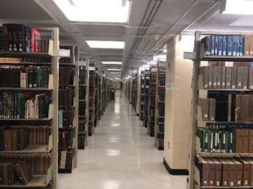 Rows of library shelves filled with books