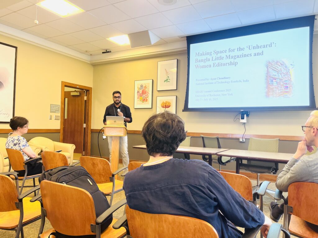 Photo of Ayab Choudury delivering his paper in front of an audience, where three scholars can be seen from the back.