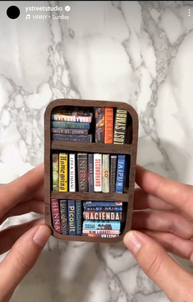 A screencap of Emma Foss’ Y Street Studios Instagram reel showing the tiny bookshelf