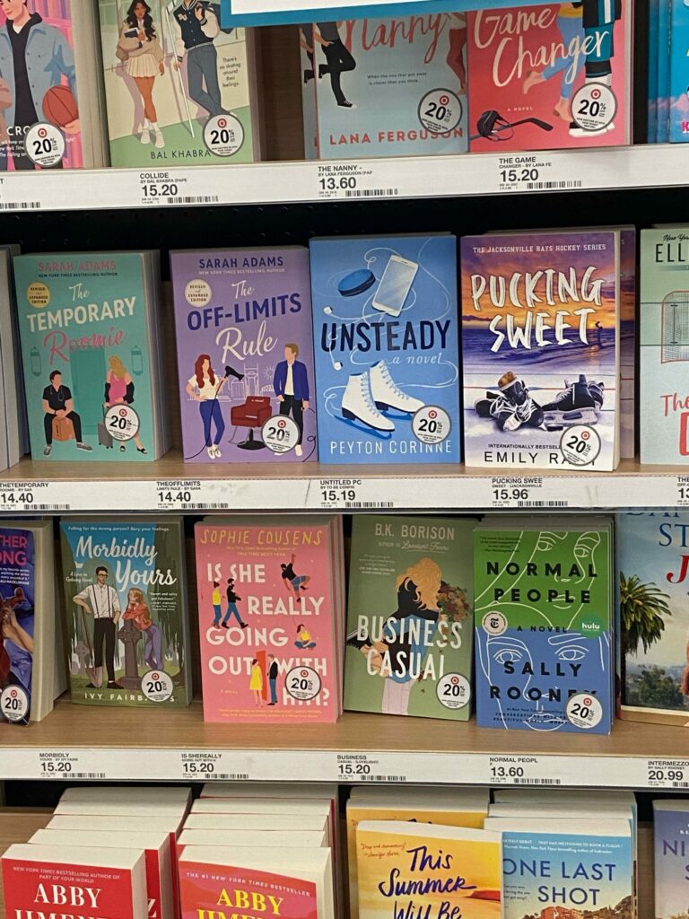 The colorful book section at a suburban Target. All romance/romance adjacent titles. Spicy content within each novel is not available.