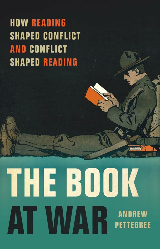 Cover of The Book at War featuring a color illustration of a soldier reading a small red book.