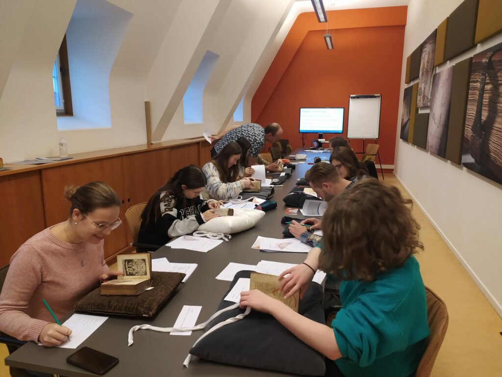 Students look at books and take notes.