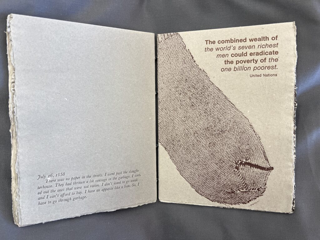 Printed sock in burgundy ink is visible on the recto of the page, accompanied by printed text, “the combined wealth of the world’s seven richest men could eradicate the poverty of the one billion poorest - United Nations.” 
